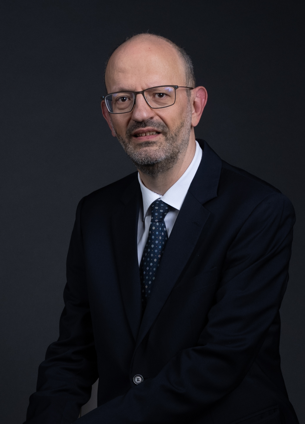 A person in a suit and tie
Description automatically generated